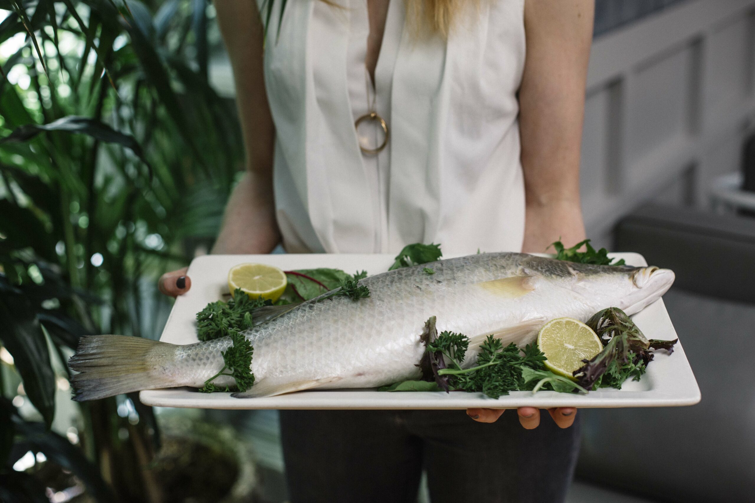 Oaks whole barramundi on a plate being served